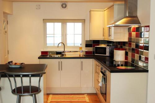 a kitchen with a sink and a counter top at Two Moors Retreat in Witheridge