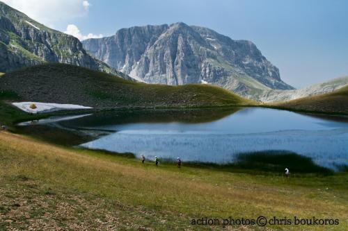 people standing around a lake in front of a mountain at Amanitis Stone House in Kipoi