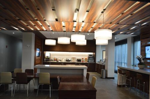 a dining room with a table and some lights at Wingate by Wyndham Kamloops in Kamloops