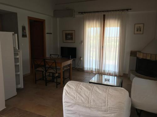 a living room with a couch and a table at Boutique Hotel Ileas Village in Arkoudi