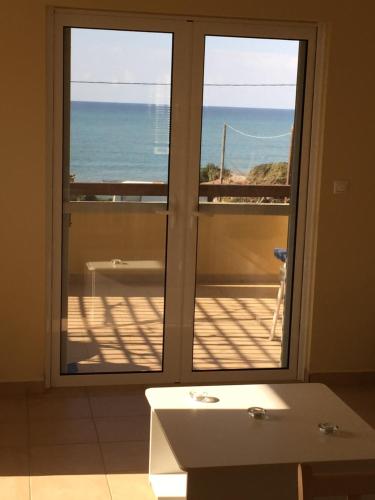 a bathroom with a view of the ocean from a window at Boutique Hotel Ileas Village in Arkoudi
