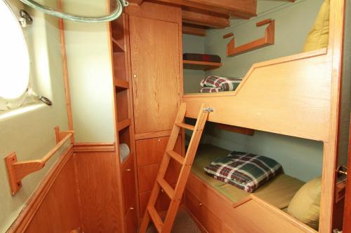 a bunk bed with a ladder in a room at Swept Away Inn in Port Alberni
