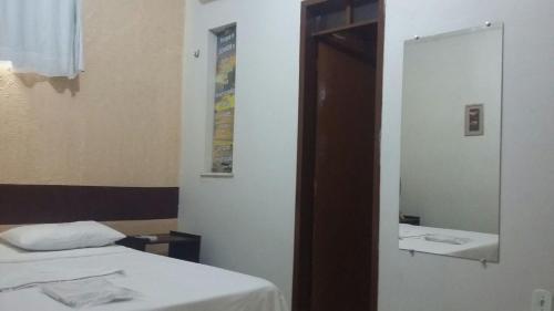 a room with two beds and a mirror at Hotel São Francisco in Tianguá