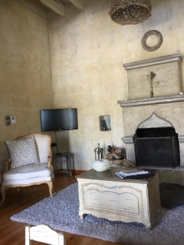 a living room with a coffee table and a fireplace at Artsistas Houses in Aristi