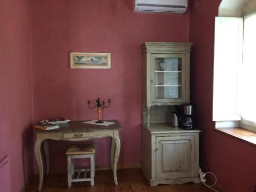 a room with a table and a cabinet and a desk at Artsistas Houses in Aristi