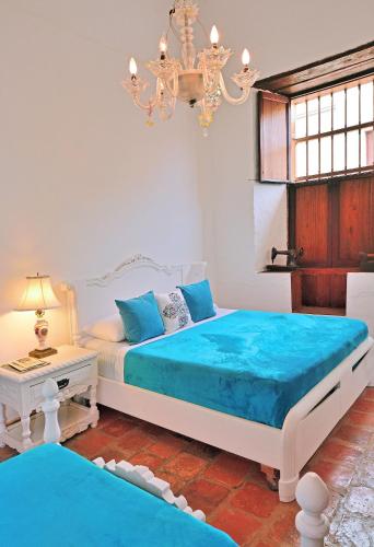 Una cama o camas en una habitación de Hotel Casa Palosanto