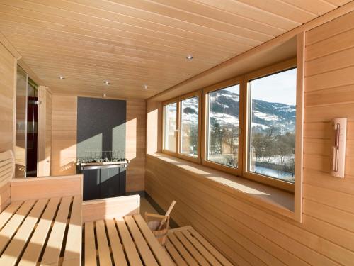 a wooden room with a bench and windows at Vergeiner's Hotel Traube in Lienz