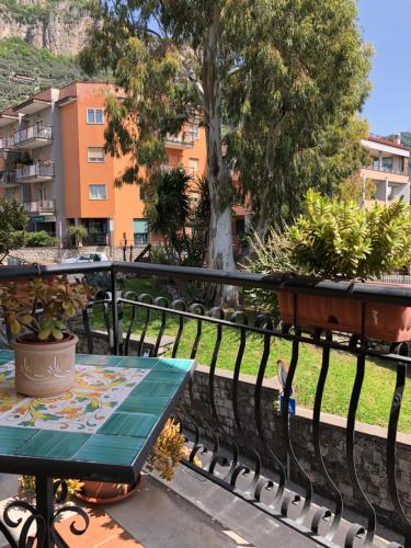 a table on a balcony with a view of a building at Sunny Holidays Casa Vacanze in Meta