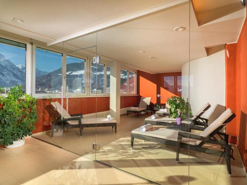 a living room with a view of the mountains at Vergeiner's Hotel Traube in Lienz