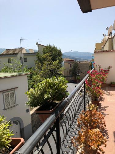 a balcony with potted plants on a building at Sunny Holidays Casa Vacanze in Meta