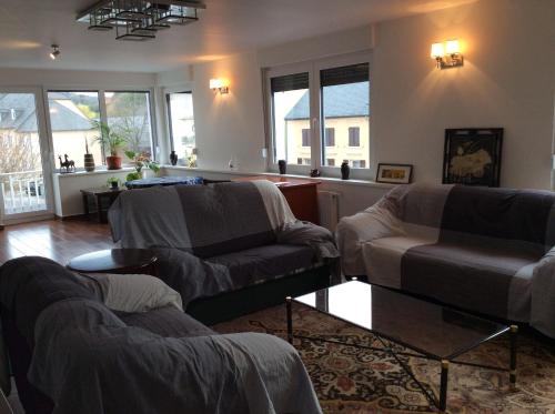 a living room with two chairs and a couch at Sanhe in Rollingen