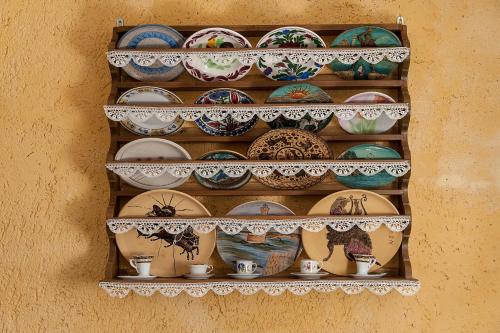 a bunch of plates and bowls on a shelf at Hamam Suites Sifaka in Chania Town