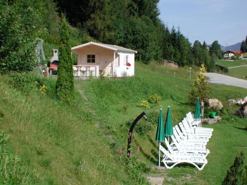 a group of white chairs sitting in a field at Landhaus Sonnenzauber in Oberau