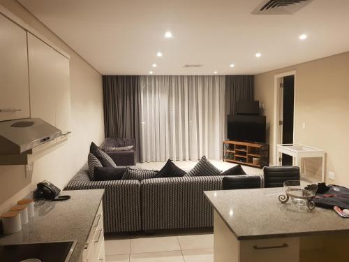 a living room with a couch and a television at 126 Beacon Rock in Durban