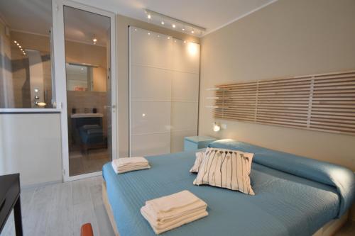 a bedroom with a blue bed with towels on it at Angelica e Orlando in Trapani