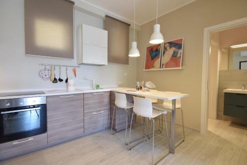 a kitchen with a table and some chairs in it at Angelica e Orlando in Trapani