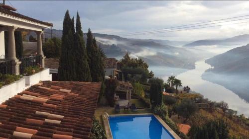 a house with a swimming pool overlooking a lake at Casa De Canilhas in Mesão Frio