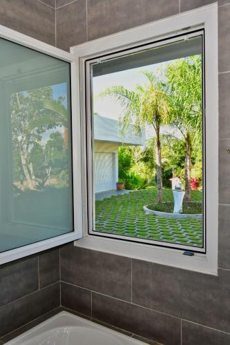 a bathroom with a window and a bath tub at Sand Dollar Villa in Boca Chica