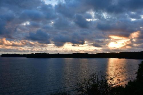 a sunset over a large body of water at Sand Dollar Villa in Boca Chica