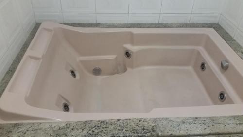 a large white bath tub in a bathroom at America Motel (ADULT ONLY) in Vila Anastácio