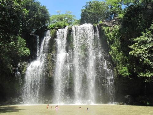 people standing in the water at a waterfall at Coco Beach Home in Coco