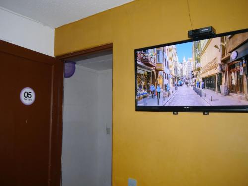 a flat screen tv on the wall of a building at Hostel Hospedarte Chapultepec in Guadalajara