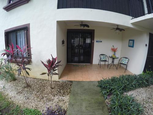 a patio of a house with two chairs and a table at Coco Beach Home in Coco