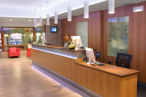 a lobby with a reception desk with a laptop on it at Maisonnave in Pamplona