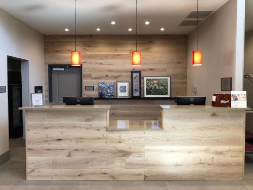 a restaurant with a wooden counter with two lights at Country Inn & Suites by Radisson, Page, AZ in Page