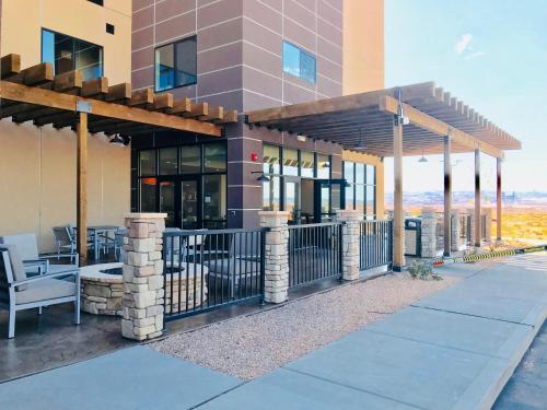 
a building that has a patio area with chairs and umbrellas at Country Inn & Suites by Radisson, Page, AZ in Page
