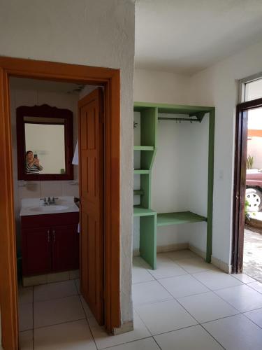 a bathroom with a sink and a mirror at Hotel Calafia in La Paz