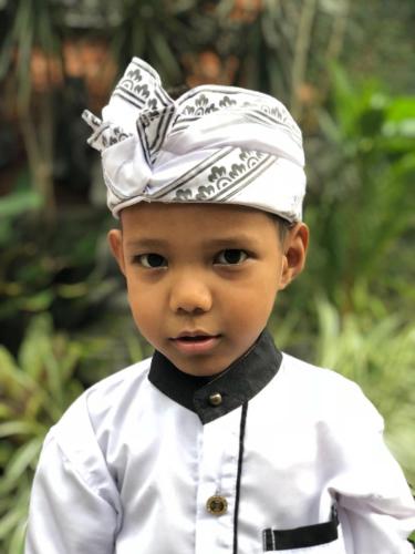 a little boy wearing a hat and a bow tie at Villa Campi Sorga in Senggigi 