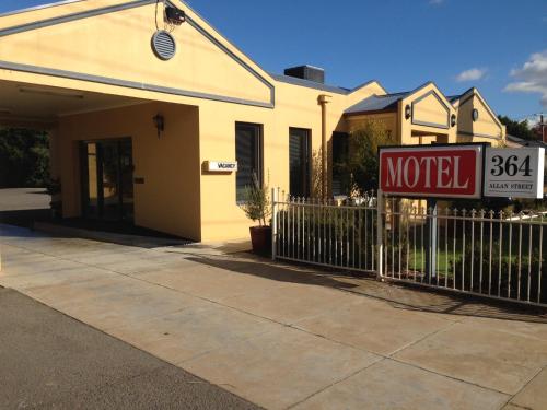 a motel sign in front of a house at Kyabram Motor Inn in Kyabram