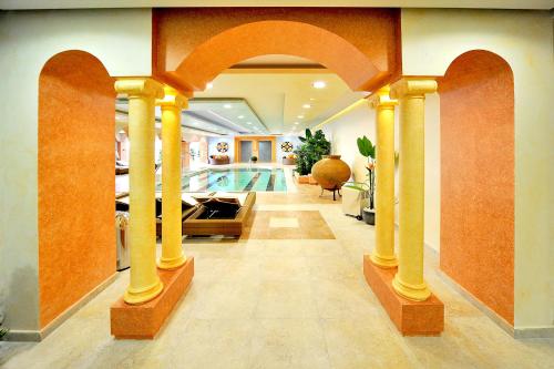 a house with a swimming pool and an archway with a swimming pool at Gaia Palace in Mastichari
