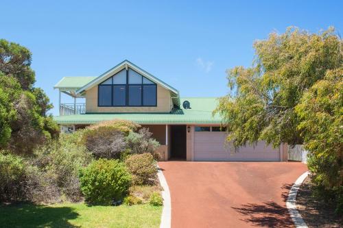 a house with a green roof and a driveway at The Southouse Beachouse in Gnarabup