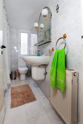a bathroom with a sink and a toilet and a mirror at Despoina Town House in Limassol