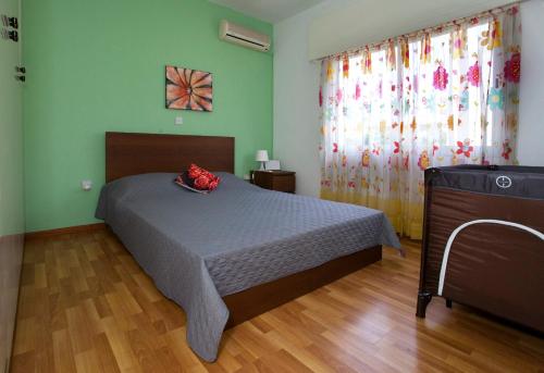 a bedroom with a bed and a television in it at Despoina Town House in Limassol