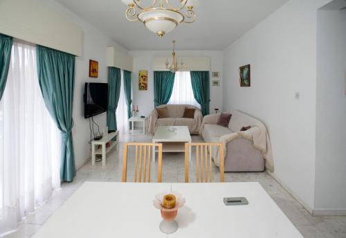 a living room with a couch and a table at Despoina Town House in Limassol
