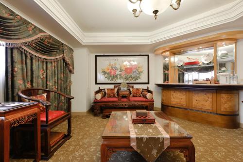 a living room with a couch and a table at Hotel Sunshine in Kaohsiung