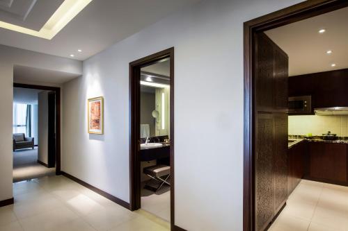 a hallway with a mirror and a kitchen at Bab Al Qasr Residence in Abu Dhabi