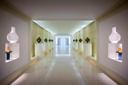 a hallway with vases on display in a museum at Bab Al Qasr Residence in Abu Dhabi