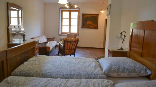 a bedroom with a bed and a desk and a chair at Ferienhaus Pfistermühle in Wissembourg