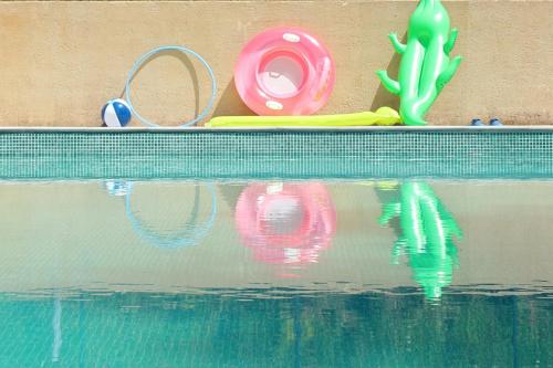 a close up of a swimming pool with some toys and water at Maison Poche in Caupenne-dʼArmagnac