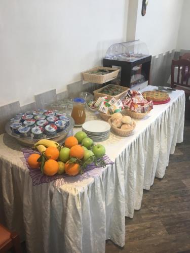 a table with a bunch of fruit on it at Rianna Rooms & Breakfast in Scala