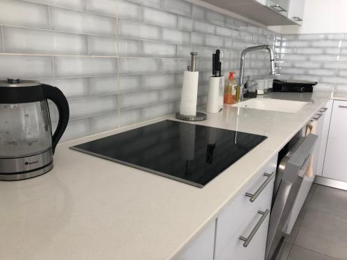 a kitchen with a counter top with a sink at Panorama Apartment " City Garden " in Bat Yam