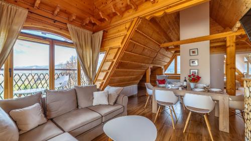 a living room with a couch and a table at Aparthotel Delta Boutique in Kościelisko