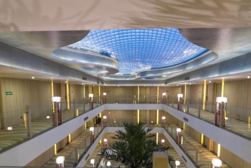 a large lobby with a ceiling with a blue ceiling at Shakun Hotels And Resorts in Jaipur