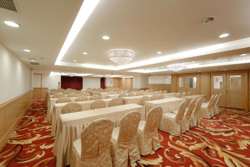 a large room with rows of tables and chairs at Hotel Sunshine in Kaohsiung