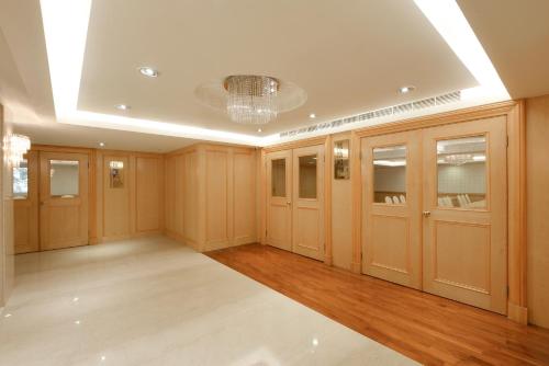 a large room with wooden cabinets and a chandelier at Hotel Sunshine in Kaohsiung