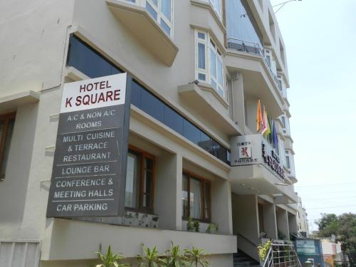 a hotel k square with a sign in front of it at Hotel K Square in Kolhapur
